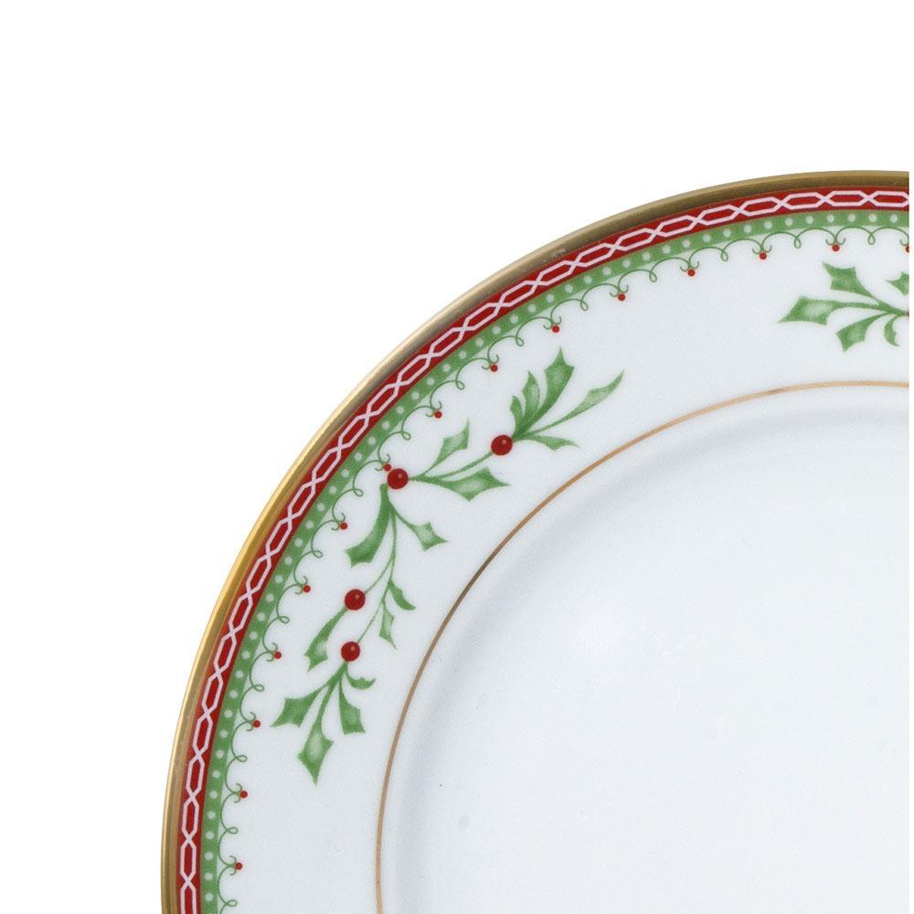 Close up of a Holiday Traditions dinner plate edge with green holly and red berries, red lattice border, and gold trim.