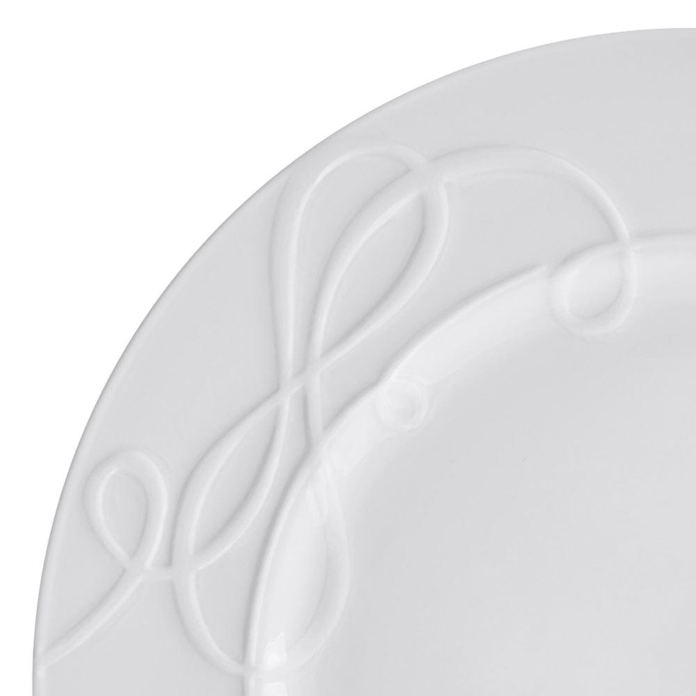Close up of white Love Story dinner plate with embossed looping pattern along the rim