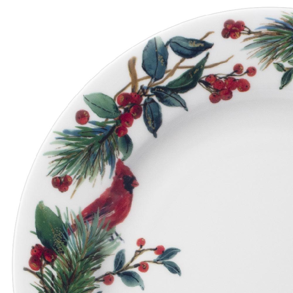 Close up of Winter Cardinal plate edge with pine needles holly and a red cardinal perched on a branch.